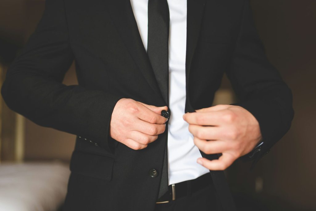 man in black suit jacket and white dress shirt