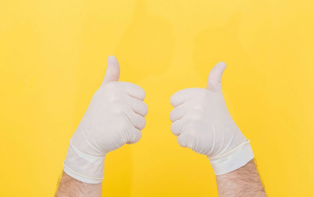 person in white long sleeve shirt doing thumbs up sign